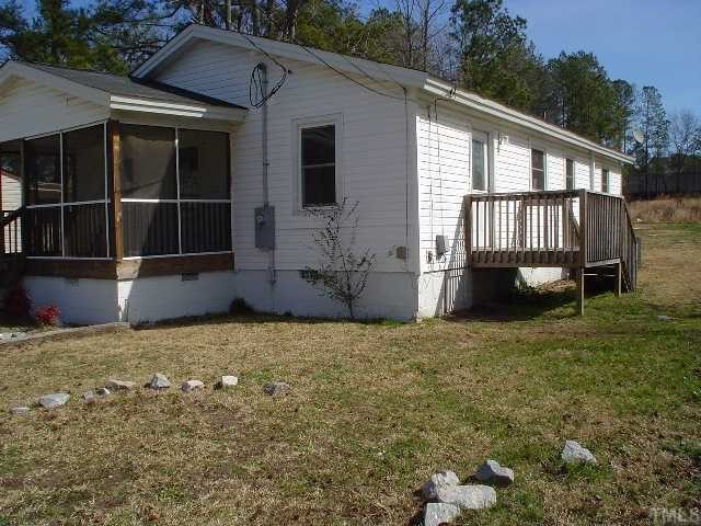 213 New Rand Road Garner, NC 27529 - Photo 2 of 3 a front view of a house with a garden