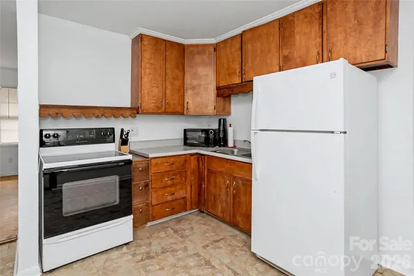 a kitchen with a refrigerator sink stove and cabinets