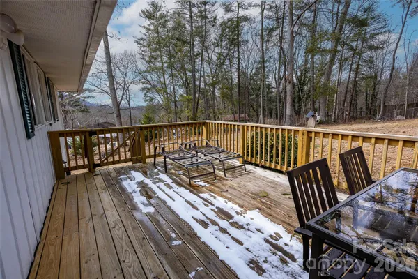 a view of balcony with wooden floor and fence