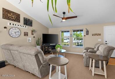 552 Spur Court Fernley, NV 89408 - Photo 11 of 46 a living room with furniture a flat screen tv and a large window