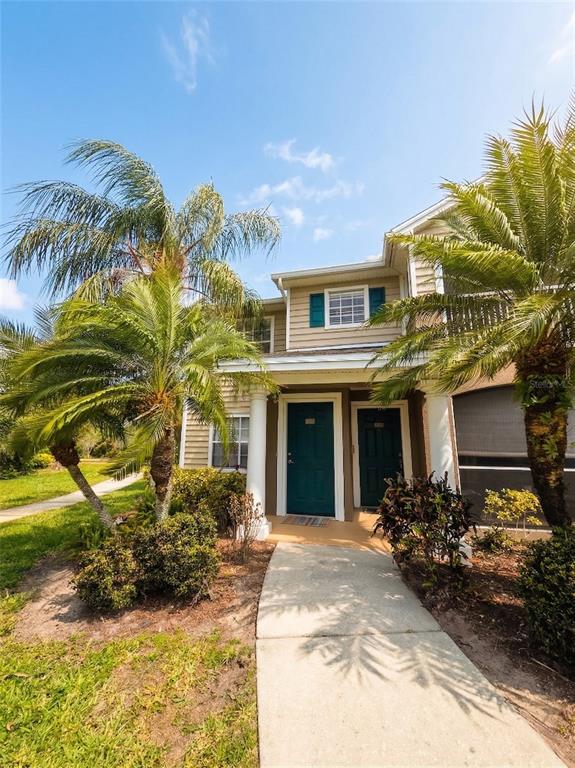 8905 Manor Loop, Unit 205 Lakewood Ranch, FL 34202 - Photo 1 of 1 a view of a house with a yard and potted plants