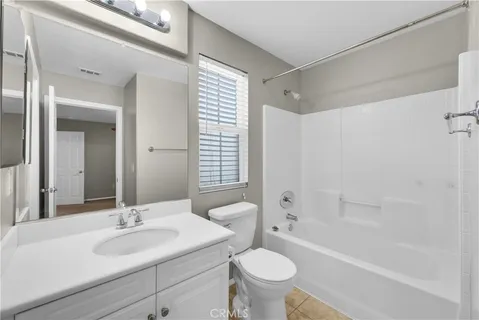 a bathroom with a sink toilet a mirror and shower
