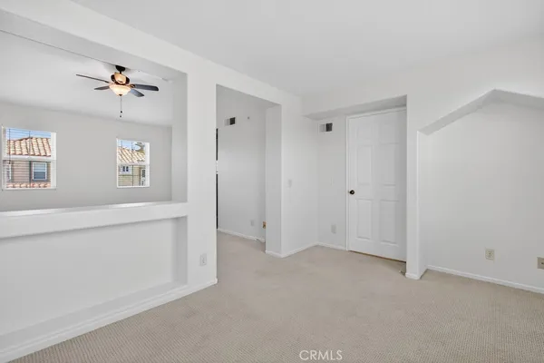 a view of a kitchen with a sink and dishwasher a refrigerator with white cabinets