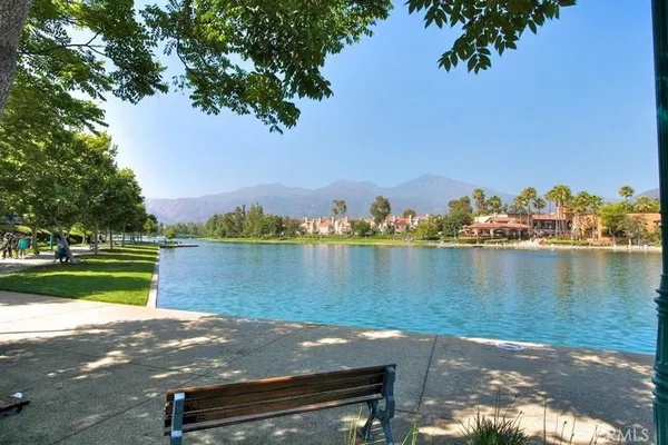 a view of a backyard with plants and lake view