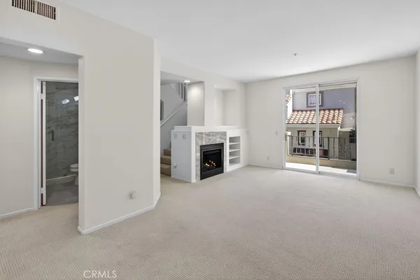 a view of a big room with windows and cabinet