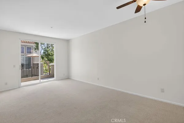 a balcony with tall trees in front of it