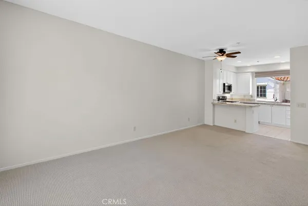 a kitchen with granite countertop a sink stove and microwave