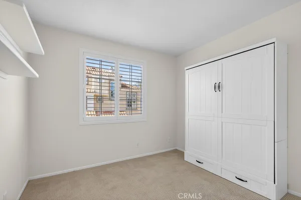a bathroom with a granite countertop sink a mirror and a shower