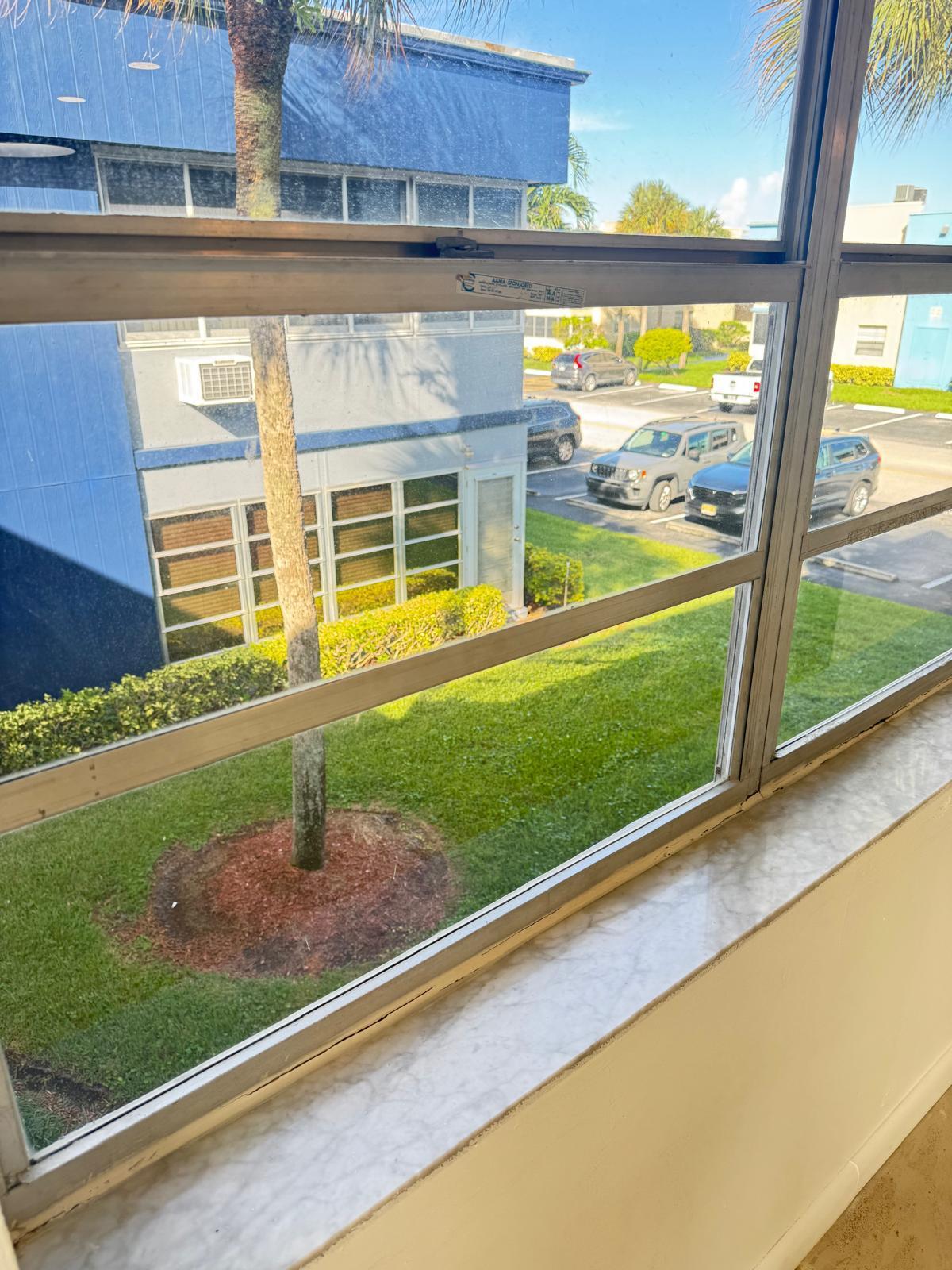 266 Burgundy Avenue, Unit 266 Delray Beach, FL 33484 - Photo 11 of 14 a front view of a house with garden