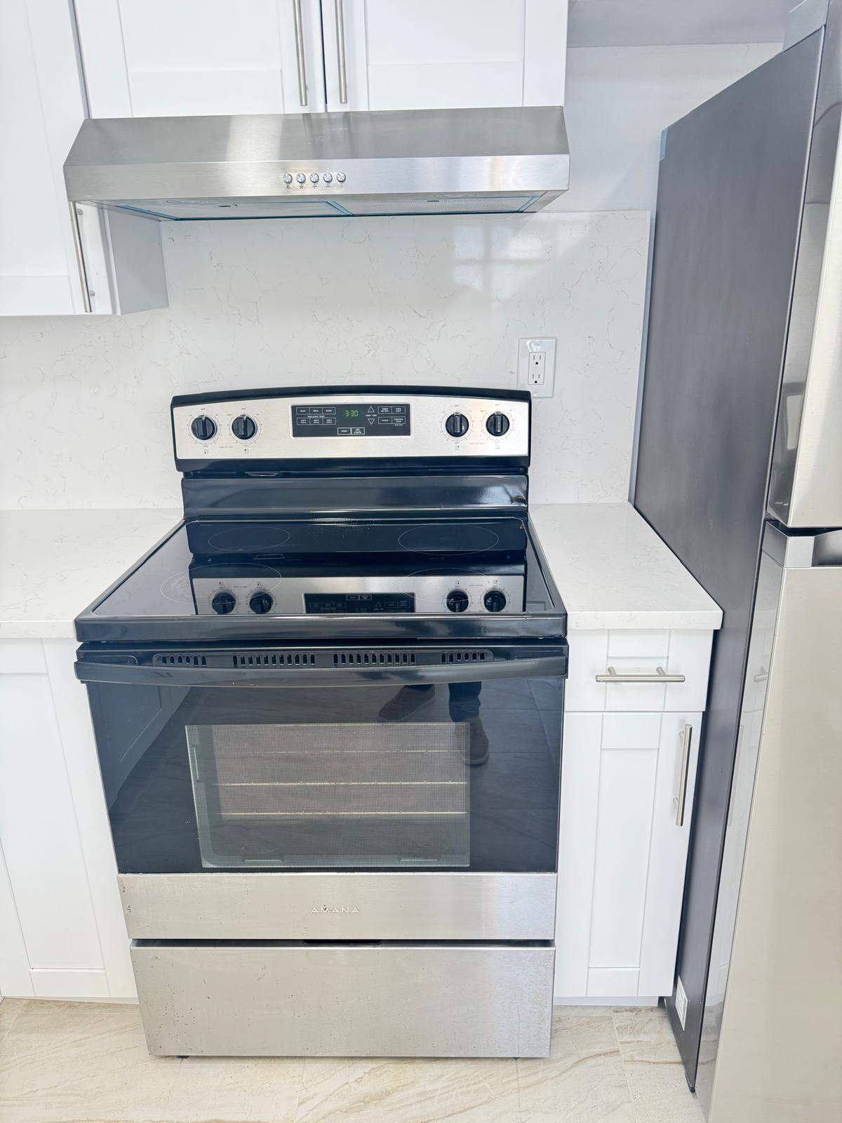 266 Burgundy Avenue, Unit 266 Delray Beach, FL 33484 - Photo 3 of 14 a stove top oven sitting inside of a kitchen