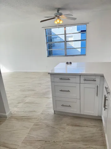 a view of room with window and cabinet