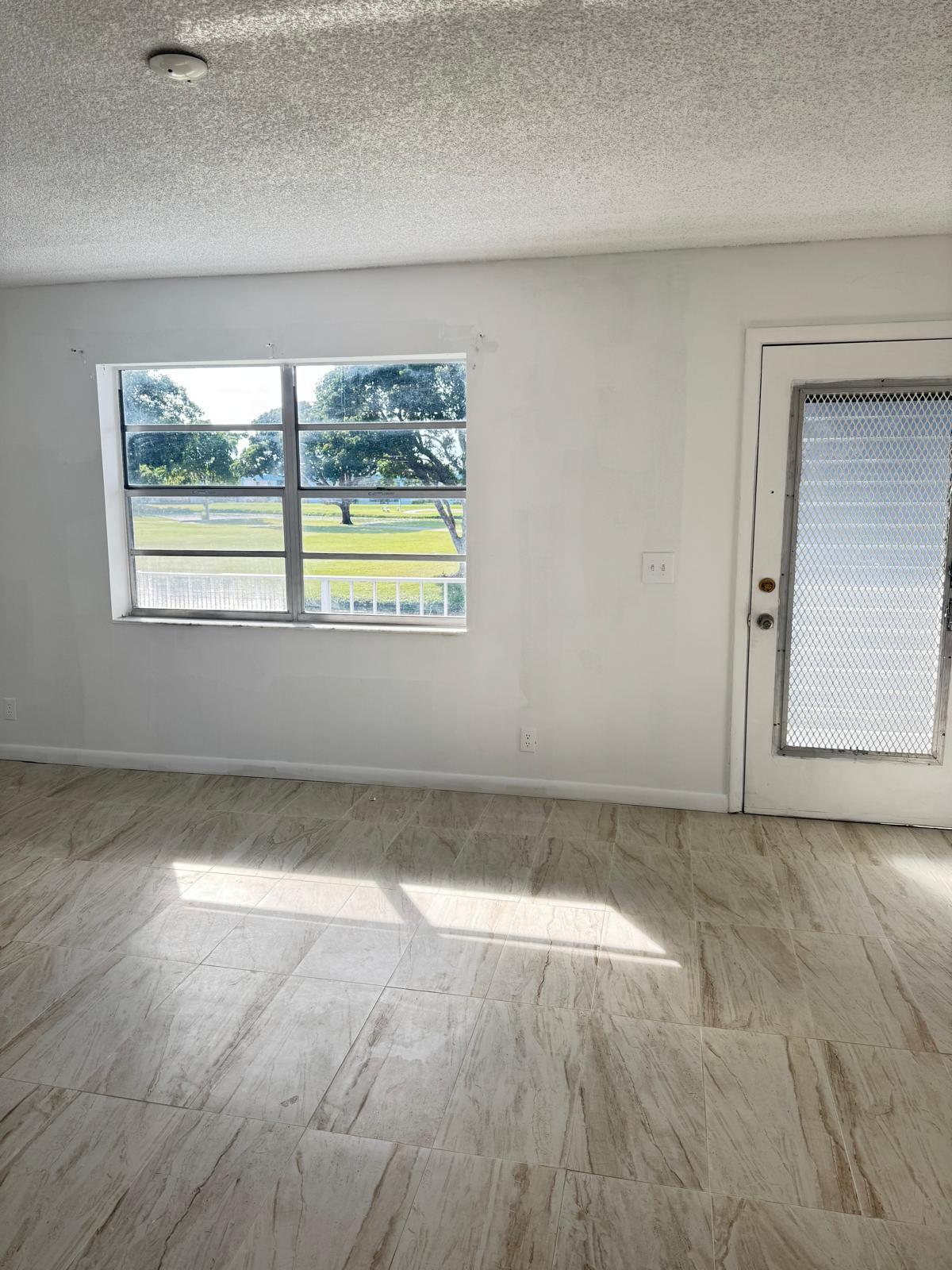 266 Burgundy Avenue, Unit 266 Delray Beach, FL 33484 - Photo 6 of 14 an empty room with a window