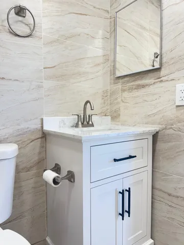a bathroom with a sink toilet and mirror