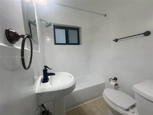 an empty room and a bathroom with a toilet