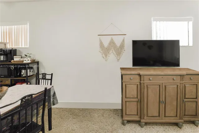 a room with furniture and flat screen tv