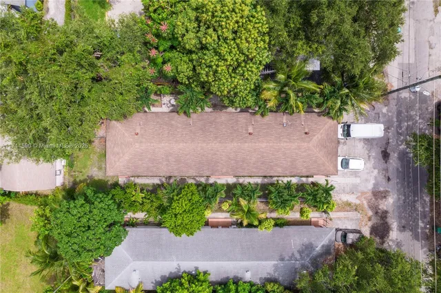 an aerial view of a house with a yard