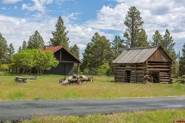 a view of house with swimming pool and sitting area