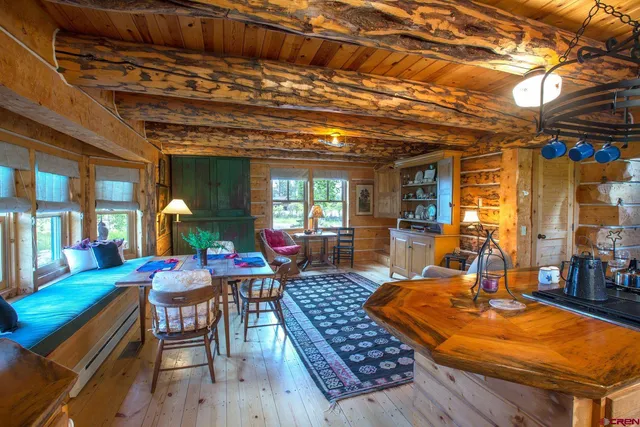 a living room with furniture a flat screen tv and kitchen view