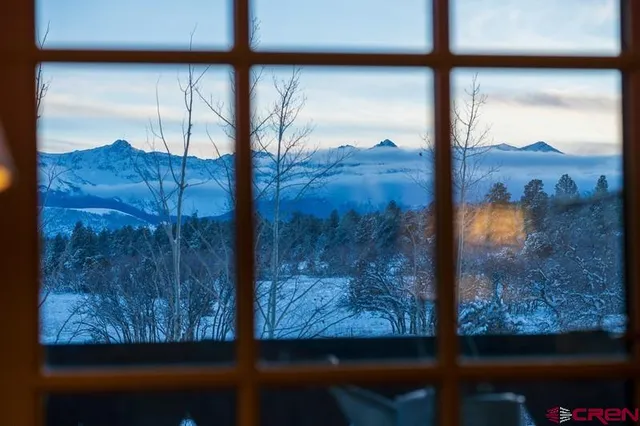 a view of house with yard and sitting area