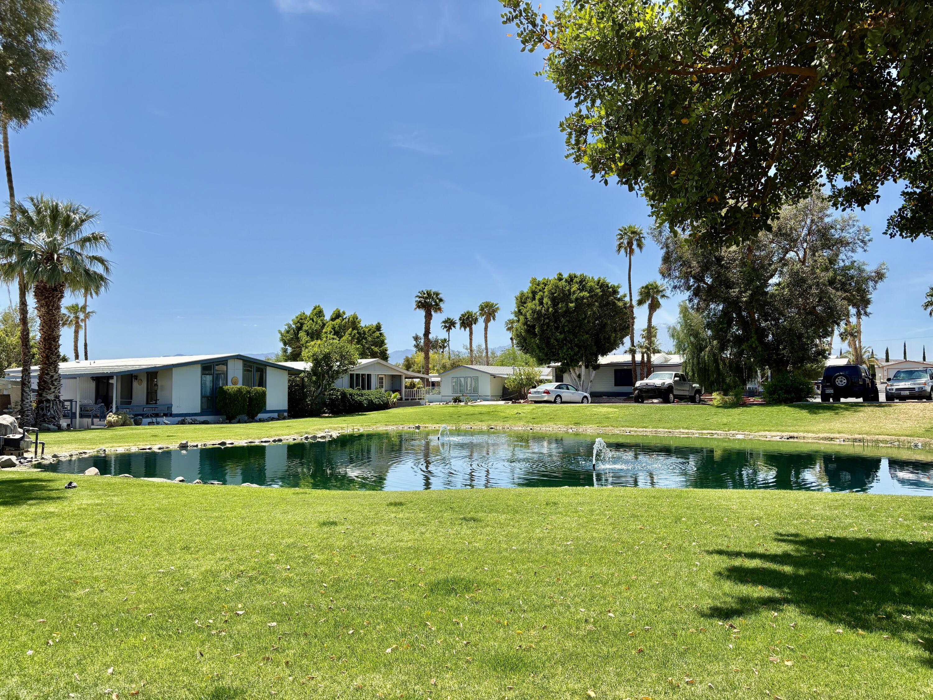 74711 Dillon Road, Unit 387 Desert Hot Springs, CA 92241 - Photo 1 of 50 a view of a swimming pool with a garden