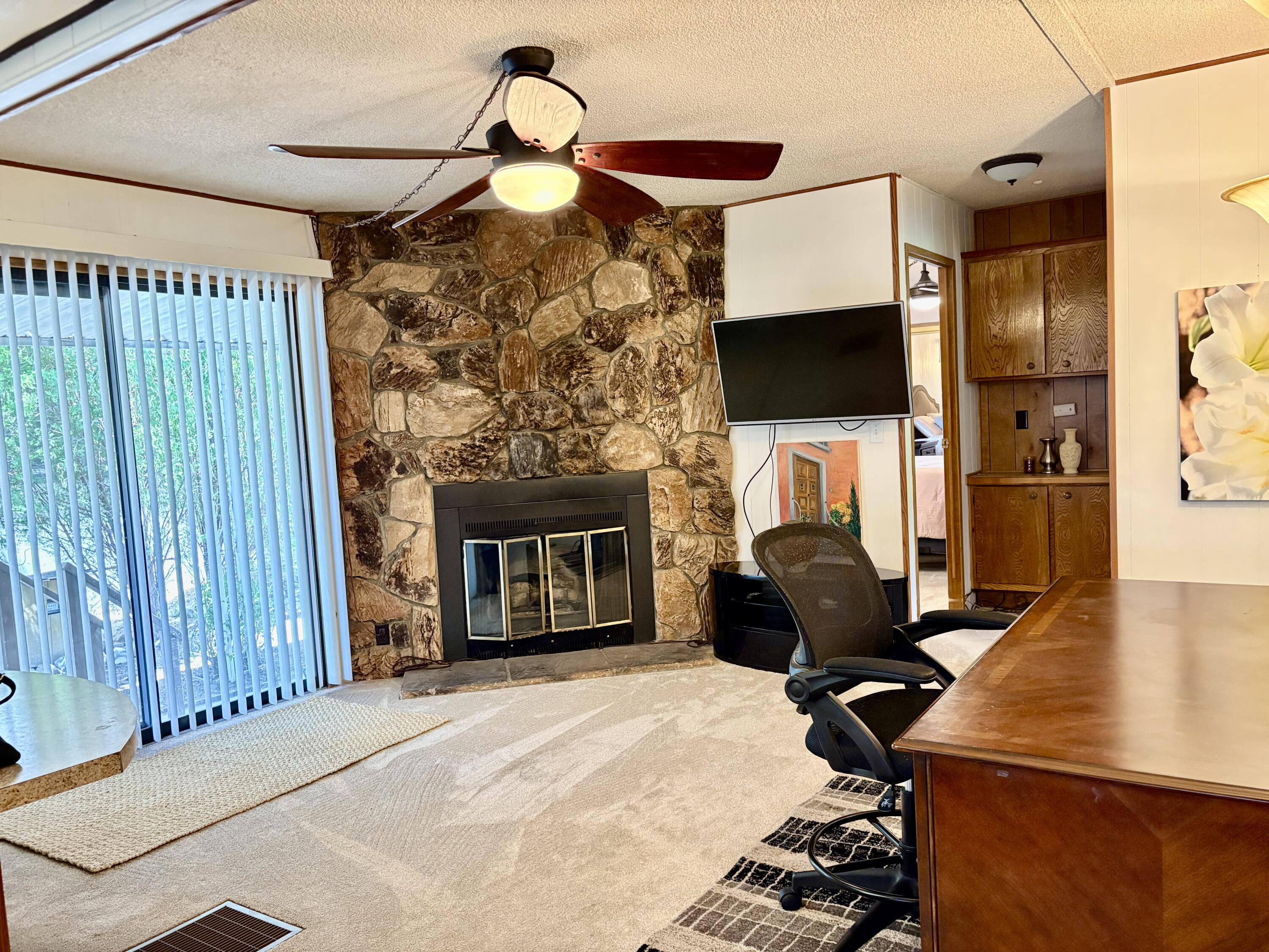 74711 Dillon Road, Unit 387 Desert Hot Springs, CA 92241 - Photo 15 of 50 a living room with furniture and a fireplace
