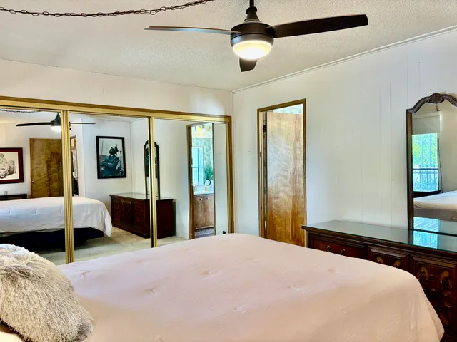 a bedroom with a large bed and a chandelier