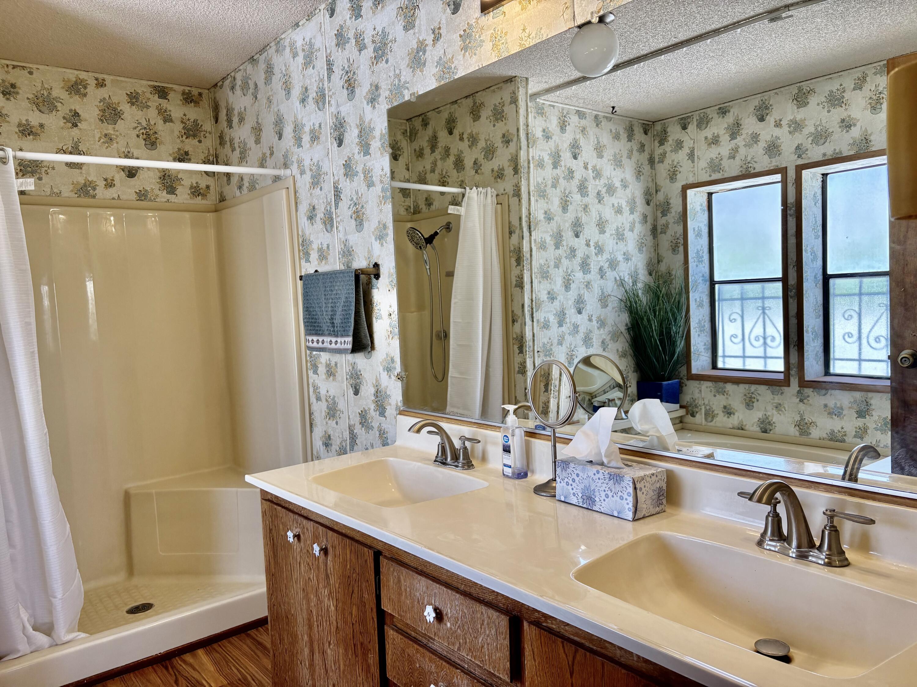 74711 Dillon Road, Unit 387 Desert Hot Springs, CA 92241 - Photo 18 of 50 a bathroom with a shower sink and mirror