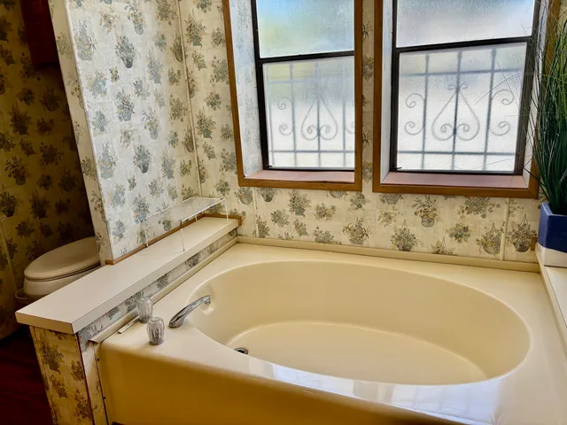 a bathroom with a bathtub and shower