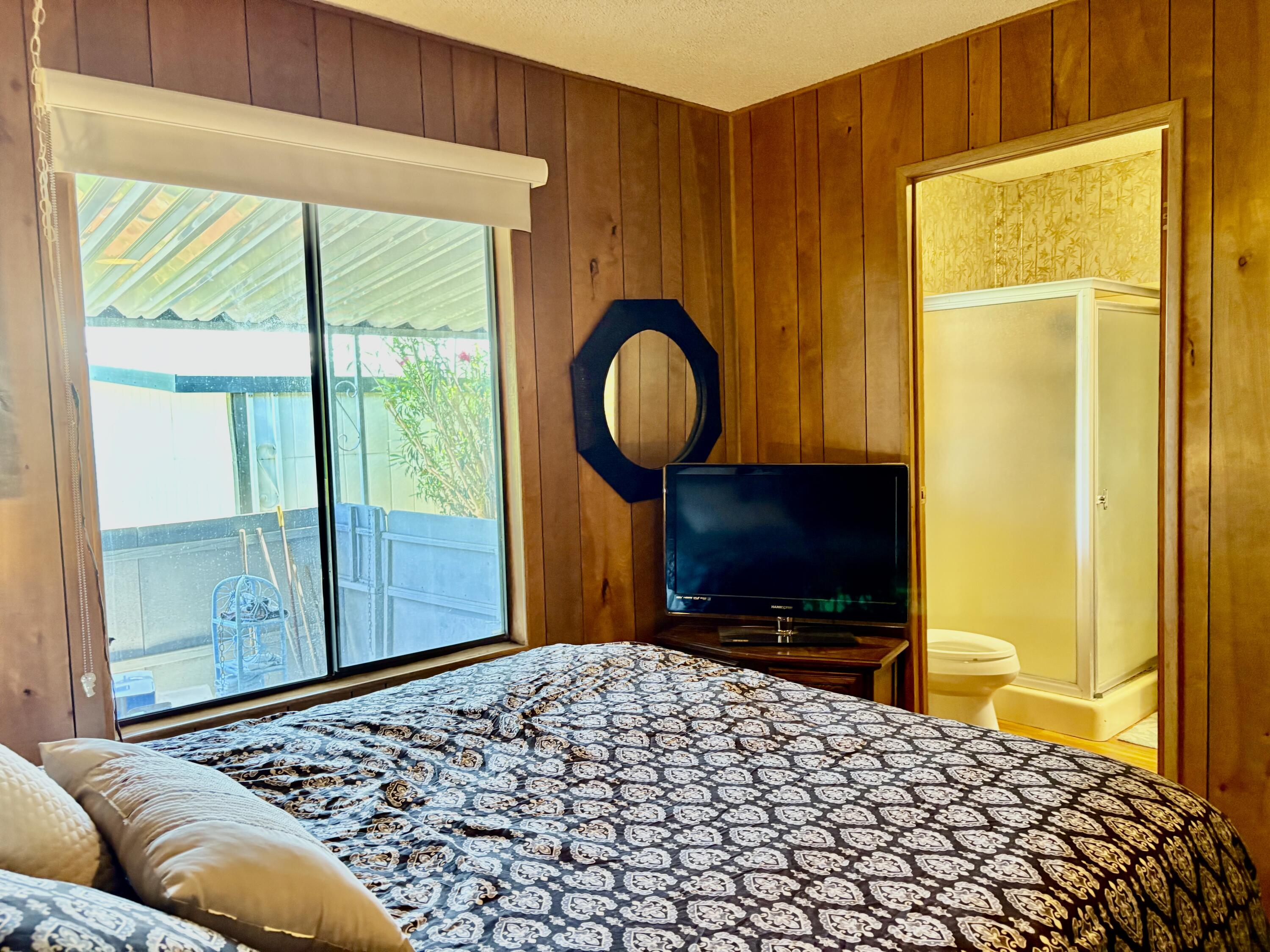 74711 Dillon Road, Unit 387 Desert Hot Springs, CA 92241 - Photo 21 of 50 a bedroom with a bed and a television