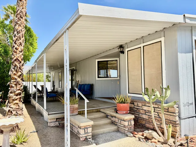 a front view of a house with outdoor seating