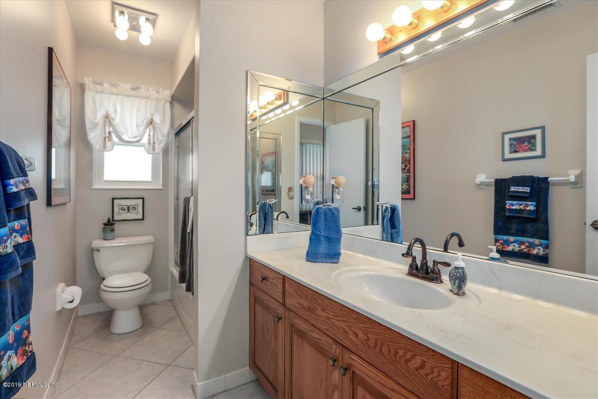 14310 Stacey Road Jacksonville, FL 32250 - Photo 11 of 20 a bathroom with a granite countertop sink mirror vanity and toilet