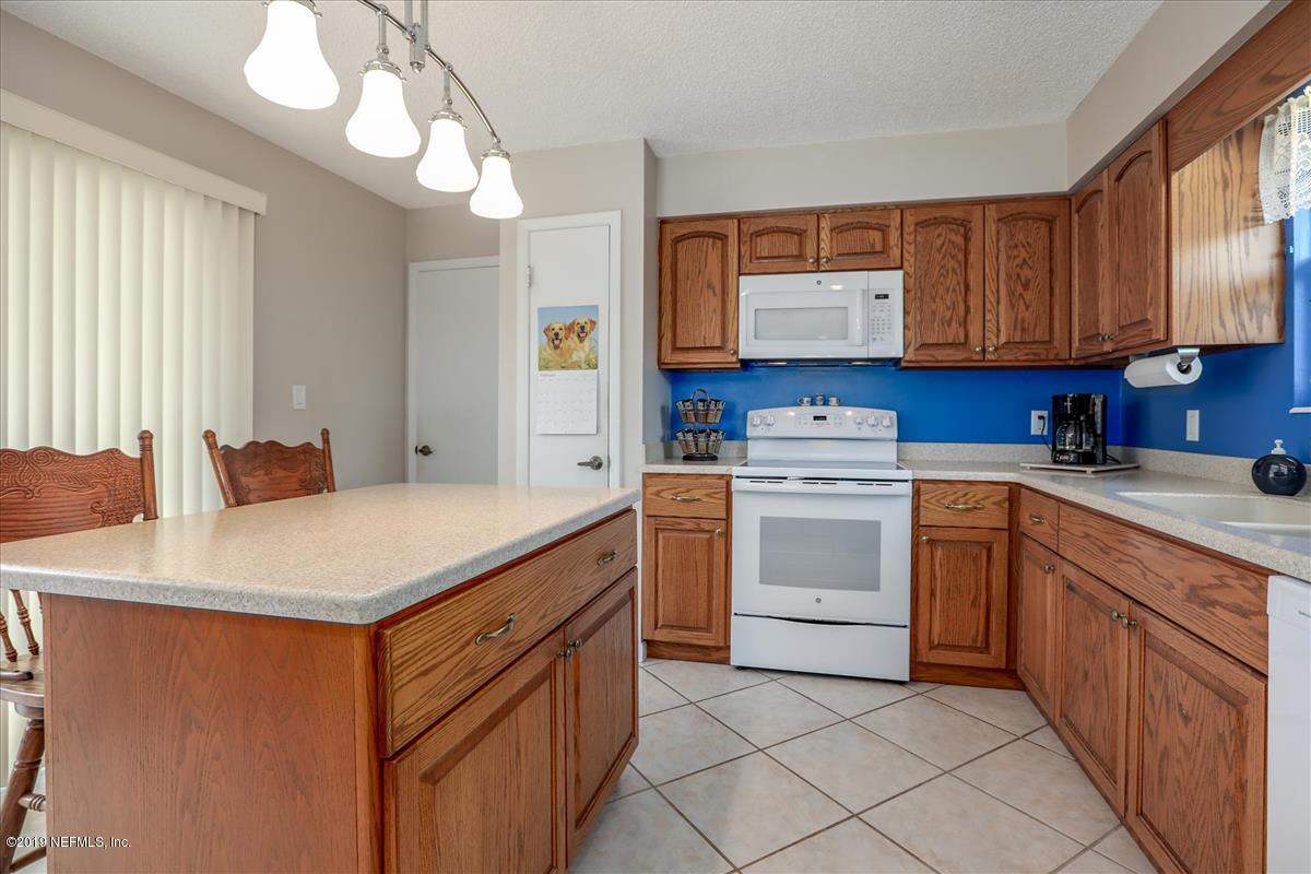 14310 Stacey Road Jacksonville, FL 32250 - Photo 7 of 20 a kitchen that has a sink a stove and a wooden cabinets