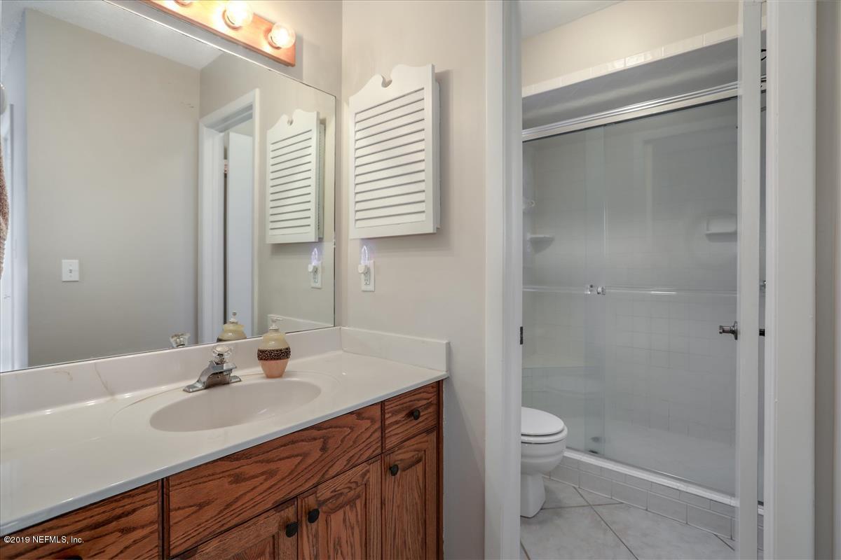 14310 Stacey Road Jacksonville, FL 32250 - Photo 9 of 20 a bathroom with a shower sink vanity mirror and toilet