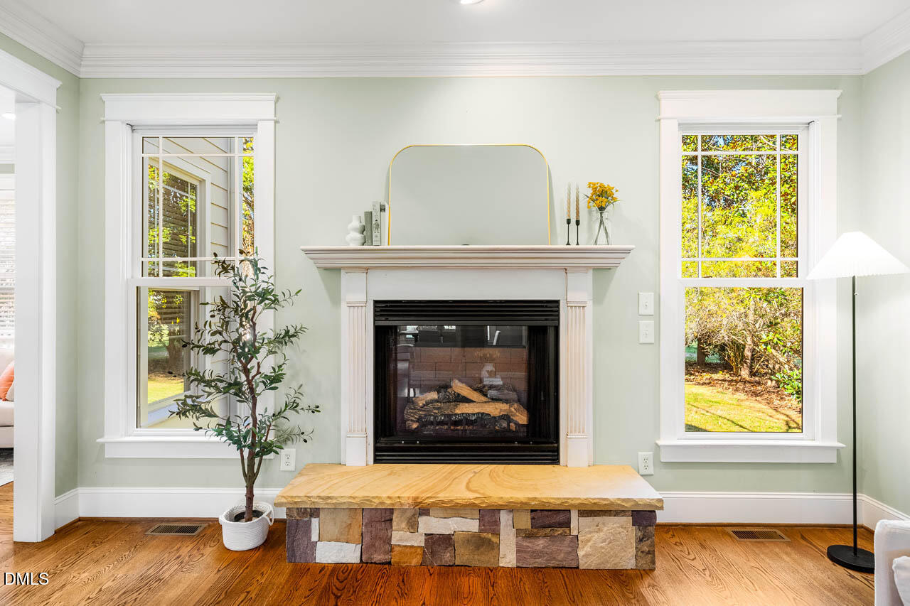 300 Long Meadows Road Chapel Hill, NC 27516 - Photo 12 of 42 a living room with a fireplace and a window