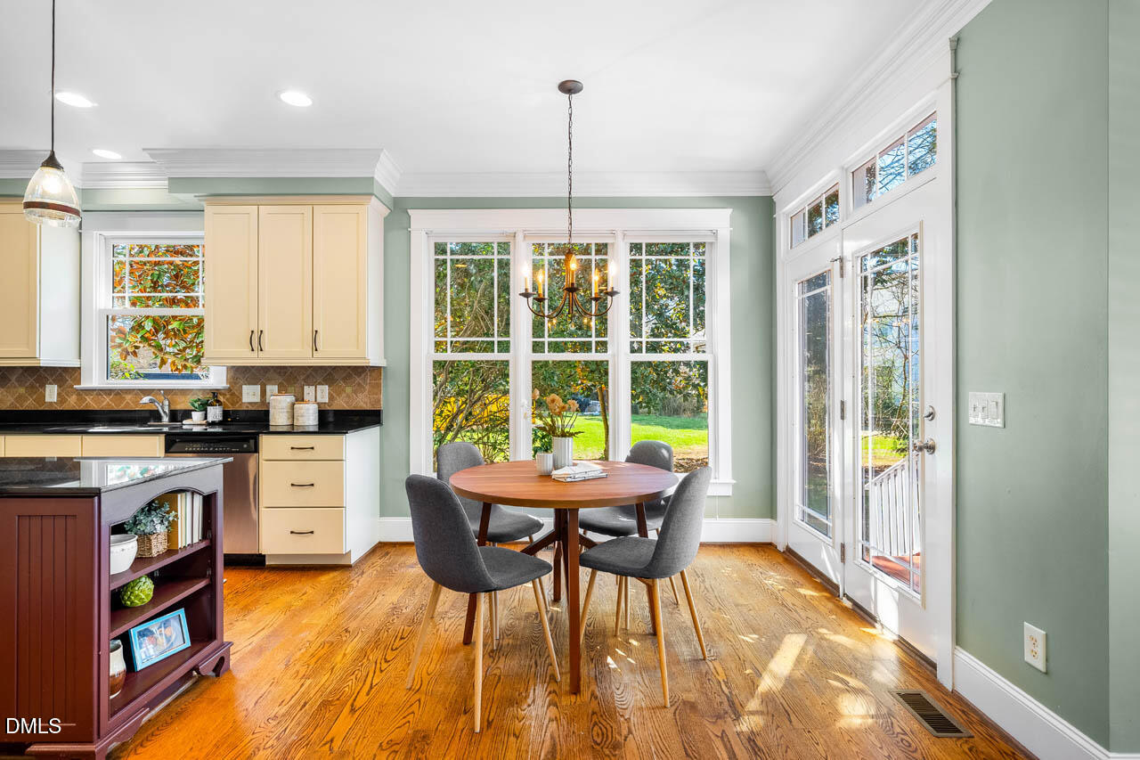 300 Long Meadows Road Chapel Hill, NC 27516 - Photo 17 of 42 a view of a dining room with furniture a chandelier and wooden floor
