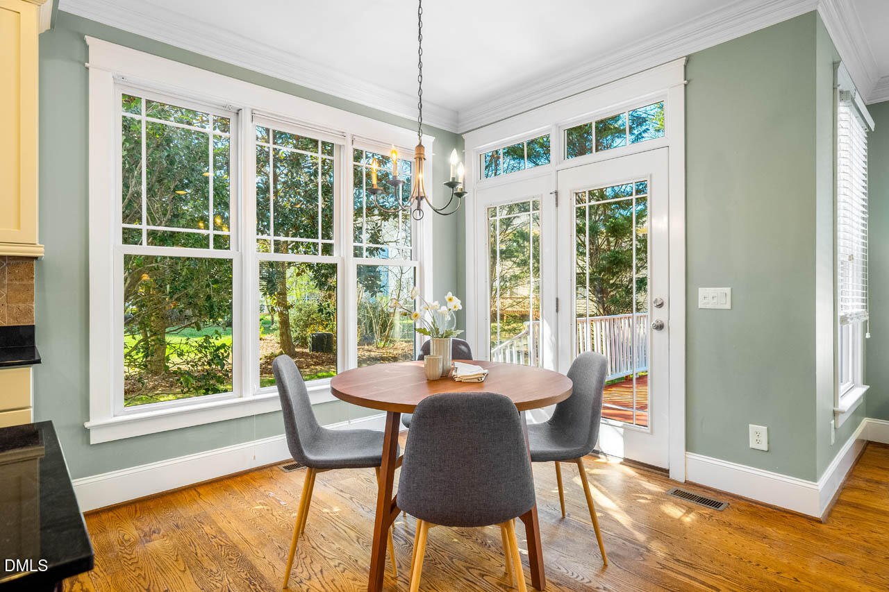 300 Long Meadows Road Chapel Hill, NC 27516 - Photo 18 of 42 a dining room with furniture large windows and wooden floor