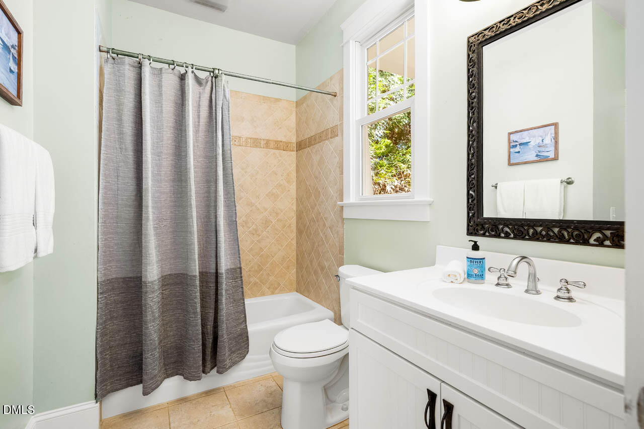 300 Long Meadows Road Chapel Hill, NC 27516 - Photo 33 of 42 a bathroom with a sink a toilet and shower curtain