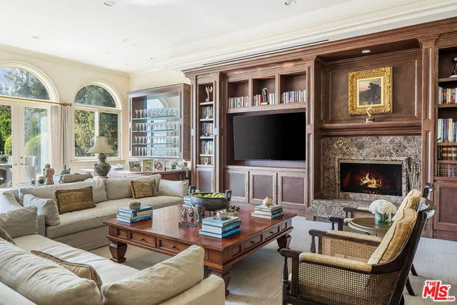 a living room with furniture fireplace and a flat screen tv