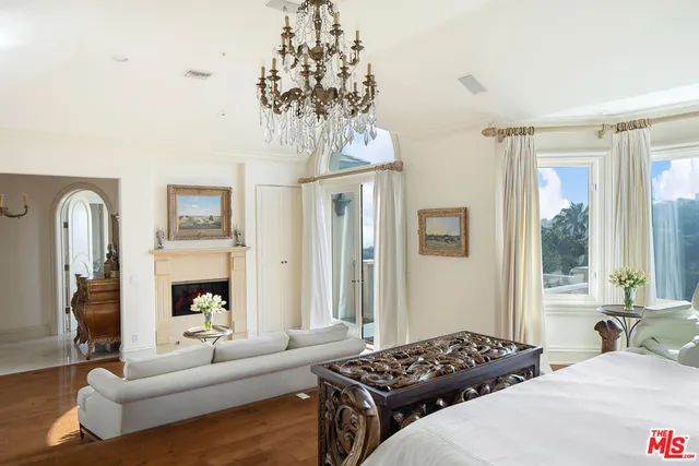 a bedroom with furniture and a chandelier