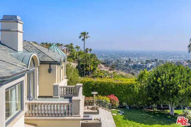 a view of a house with a garden and pathway