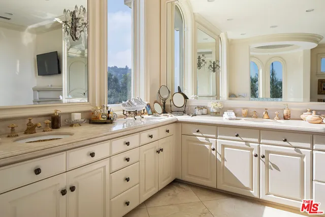 a bathroom with a sink double vanity and a mirror