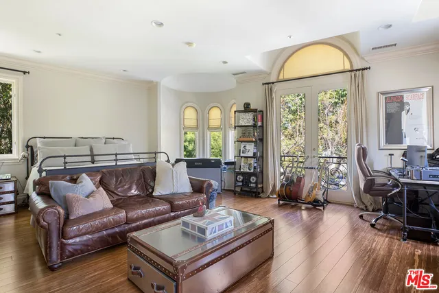 a living room with furniture and a floor to ceiling window