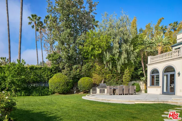 a view of house with garden space and trees