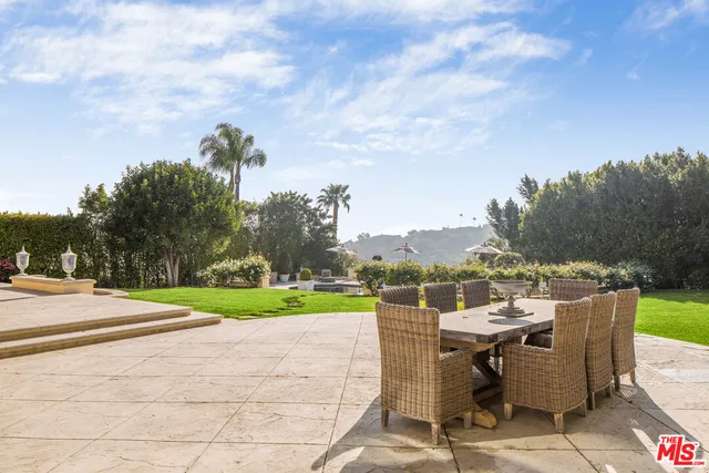 a view of a terrace with a garden and trees
