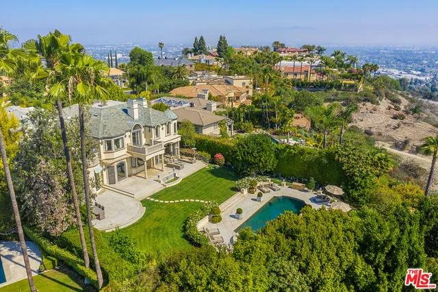 an aerial view of multiple houses with yard
