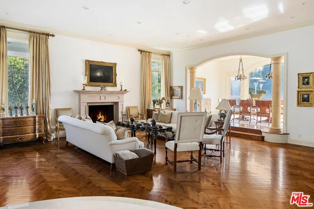 a living room with furniture fireplace and a table