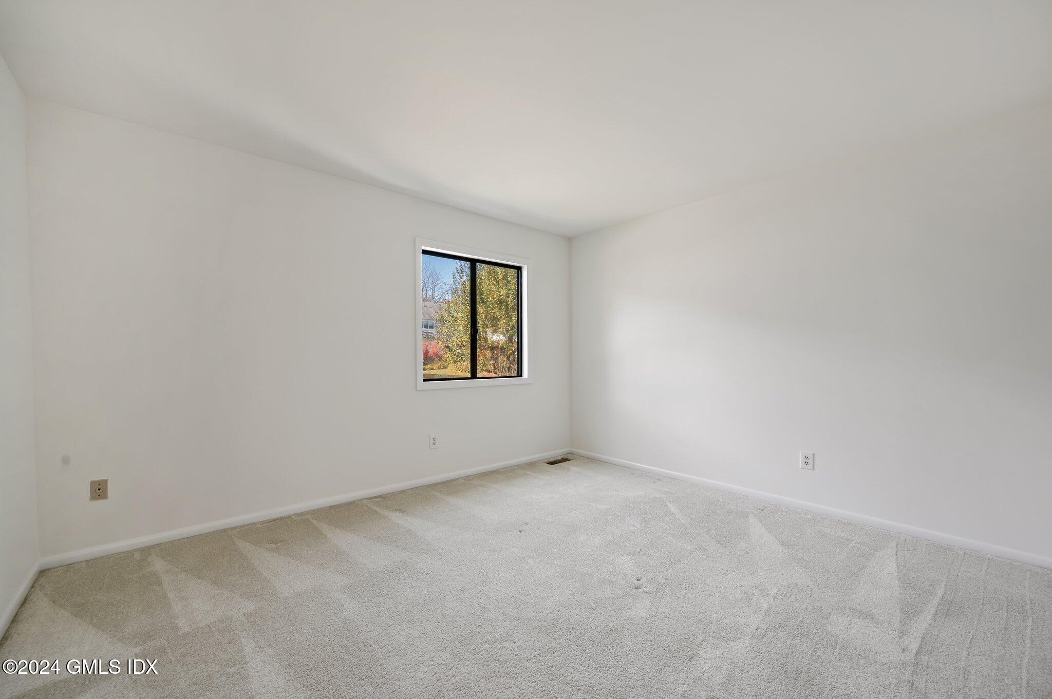 75 Silo Circle, Unit 75 Riverside, CT 06878 - Photo 27 of 53 a view of an empty room with a window