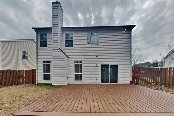 a view of a house with wooden deck