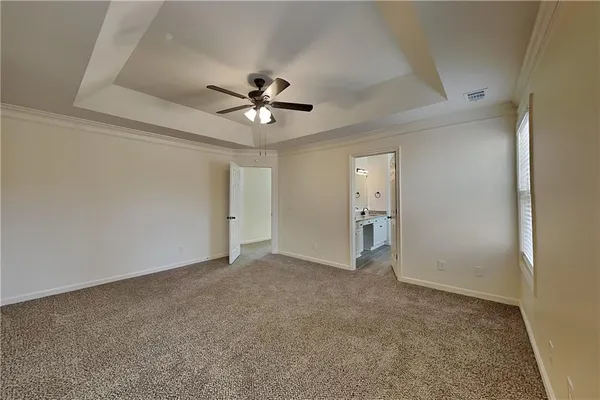 a view of an empty room with a ceiling fan