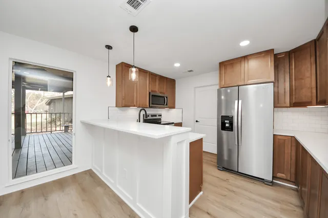 a view of a livingroom with a ceiling fan and window